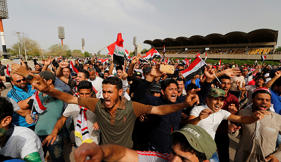 Followers of Iraq's Shi'ite cleric Moqtada al-Sadr shout slogans at Grand Festivities Square within the Green Zone in Baghdad